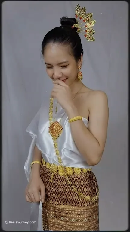 Beautiful thai girl dancing in a traditional dress with some surprise twist